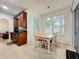 Kitchen and dining area with cherry wood cabinets and tile flooring at 9525 Southern Garden Cir, Altamonte Springs, FL 32714