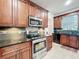 Updated kitchen boasting dark wood cabinetry, stainless steel appliances, and attractive backsplash detailing at 9525 Southern Garden Cir, Altamonte Springs, FL 32714