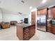Open kitchen and living area, with a central island, stainless steel appliances, and cozy seating space at 9525 Southern Garden Cir, Altamonte Springs, FL 32714