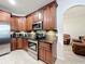Well-equipped kitchen showcasing dark wood cabinetry, stainless steel appliances, and granite countertops at 9525 Southern Garden Cir, Altamonte Springs, FL 32714