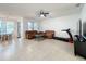 Spacious living room with tiled floors, tan sofas, and natural light at 9525 Southern Garden Cir, Altamonte Springs, FL 32714