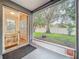 Screened-in patio with sliding glass door provides backyard views with shade from a large tree at 9525 Southern Garden Cir, Altamonte Springs, FL 32714