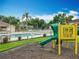 Attractive community playground with a slide and various play equipment, surrounded by lush landscaping at 9525 Southern Garden Cir, Altamonte Springs, FL 32714