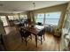 Open dining area with wood floors and a view to kitchen and the outdoors at 2094 Penn Dr, Deland, FL 32724