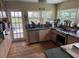 Galley kitchen with granite counters, stainless appliances, and plentiful natural light at 2094 Penn Dr, Deland, FL 32724