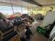 Covered porch area filled with household items and a grill at 2094 Penn Dr, Deland, FL 32724