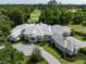 Stunning aerial view of a large luxury home with a patterned driveway and meticulously manicured lawn and gardens at 8707 Nw 31St Lane Rd, Ocala, FL 34482