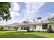 Expansive backyard featuring a home with a white exterior, grey roof, and covered patio at 8707 Nw 31St Lane Rd, Ocala, FL 34482