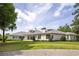Beautiful backyard featuring a home with a white exterior, grey roof, and covered patio at 8707 Nw 31St Lane Rd, Ocala, FL 34482