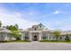 Elegant home featuring a stone facade, arched windows, stately columns and a paved circular driveway at 8707 Nw 31St Lane Rd, Ocala, FL 34482