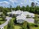Expansive home with light gray stone exterior, patterned roof, and lush landscaping creating a serene setting at 8707 Nw 31St Lane Rd, Ocala, FL 34482