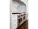 Professional grade Wolf range with double oven and custom tile backsplash offers a luxury cooking experience at 8707 Nw 31St Lane Rd, Ocala, FL 34482