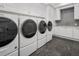 Laundry room with luxury appliances, tiled backsplash and custom storage cabinets at 8707 Nw 31St Lane Rd, Ocala, FL 34482