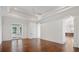 Bright room featuring a tray ceiling, arched doorway, hardwood floors and access to the outdoor living space at 8707 Nw 31St Lane Rd, Ocala, FL 34482