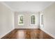 Living room featuring wood floors, white trim, and multiple windows at 8707 Nw 31St Lane Rd, Ocala, FL 34482
