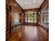 Spacious wood-paneled office with custom built-ins, hardwood floors, recessed lighting, and large windows overlooking the yard at 8707 Nw 31St Lane Rd, Ocala, FL 34482