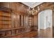 Executive office boasts beautiful hardwood floors, rich wood paneling, custom built-in shelving, and elegant lighting at 8707 Nw 31St Lane Rd, Ocala, FL 34482