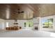 Spacious outdoor living area with wood ceiling, outdoor kitchen, and fireplace at 8707 Nw 31St Lane Rd, Ocala, FL 34482