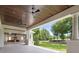 Covered patio with wood ceiling, outdoor kitchen, fireplace, and view of the backyard at 8707 Nw 31St Lane Rd, Ocala, FL 34482