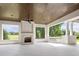 Covered patio with wood ceiling, fireplace, columns, and view of the backyard at 8707 Nw 31St Lane Rd, Ocala, FL 34482