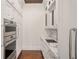 Custom pantry with wood ceiling, marble countertops, storage cabinets and built in oven at 8707 Nw 31St Lane Rd, Ocala, FL 34482