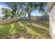 Large backyard featuring green grass and a wooden fence, perfect for outdoor activities at 294 Lake Doe Blvd, Apopka, FL 32703