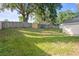Expansive backyard featuring lush green grass and a wooden fence, providing privacy and space at 294 Lake Doe Blvd, Apopka, FL 32703
