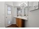 Bathroom featuring bright light, a vanity, and a door with a pet entrance at 294 Lake Doe Blvd, Apopka, FL 32703