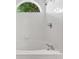 Close up of tub showing bright tiling, updated faucet, and natural light window at 294 Lake Doe Blvd, Apopka, FL 32703