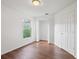 Bedroom featuring hardwood floors, a window, closet, and neutral paint at 294 Lake Doe Blvd, Apopka, FL 32703