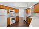 Bright kitchen with white appliances and wood cabinets, showcasing an efficient layout at 294 Lake Doe Blvd, Apopka, FL 32703