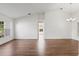 Bright living room with hardwood floors and large windows, showcasing an open floor plan at 294 Lake Doe Blvd, Apopka, FL 32703
