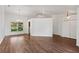 Open living room with hardwood floors, modern lighting, and neutral wall colors at 294 Lake Doe Blvd, Apopka, FL 32703
