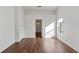 Bright living room featuring hardwood floors and natural light from a large window at 294 Lake Doe Blvd, Apopka, FL 32703