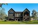 Modern two-story home with symmetrical design, large windows, and landscaped front yard at 2716 Delphi Hills Way, Lakeland, FL 33812