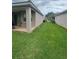 The backyard offers a covered patio and lush green lawn, ideal for relaxation and entertaining at 440 Bay Leaf Dr, Kissimmee, FL 34759