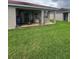 Charming covered patio with dining area and grill, perfect for enjoying the outdoors at 440 Bay Leaf Dr, Kissimmee, FL 34759
