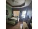 Cozy bedroom features dark accent walls, classic furnishings, and plenty of natural light at 440 Bay Leaf Dr, Kissimmee, FL 34759