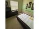 Minimalist bedroom featuring a large dresser and comfortable mattress set on the floor at 440 Bay Leaf Dr, Kissimmee, FL 34759