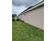 A exterior shot showcasing the side of the house with a well maintained lawn at 440 Bay Leaf Dr, Kissimmee, FL 34759