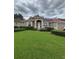Charming single-story home boasts a lush green lawn, well-manicured hedges, and a classic tile roof at 440 Bay Leaf Dr, Kissimmee, FL 34759