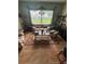 Inviting living room with tiled floors, comfortable seating, and a large window for natural light at 440 Bay Leaf Dr, Kissimmee, FL 34759