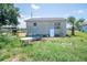 Backyard with lawn and old couch at 7043 Curtis Ave, Groveland, FL 34736
