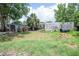 Backyard view of house with lawn and shed at 7043 Curtis Ave, Groveland, FL 34736