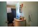 This bathroom has a blue sink, mirror, and a shower with a black curtain at 7043 Curtis Ave, Groveland, FL 34736