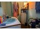 Bathroom featuring a turquoise sink, peeling walls, and old water heater at 7043 Curtis Ave, Groveland, FL 34736