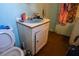 Bathroom featuring a turquoise sink, peeling walls, and a toilet at 7043 Curtis Ave, Groveland, FL 34736