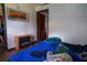 This bedroom features an electric fireplace and an abstract painting on the wall at 7043 Curtis Ave, Groveland, FL 34736