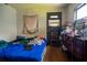 This bedroom has a blue comforter and a dresser with an air conditioner in the window at 7043 Curtis Ave, Groveland, FL 34736
