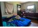 This bedroom has a blue comforter and a dresser with an air conditioner in the window at 7043 Curtis Ave, Groveland, FL 34736